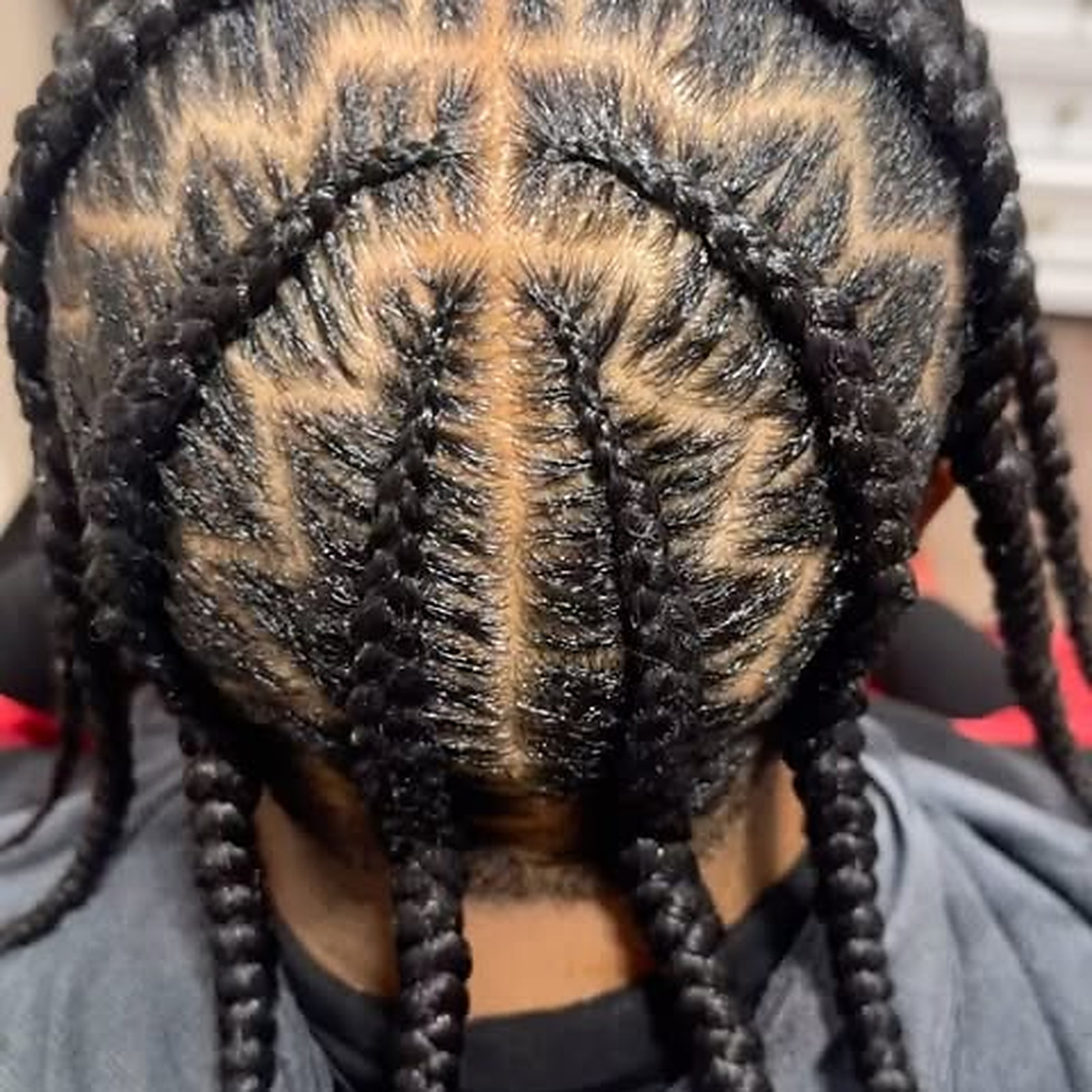 Braided down with zig-zag parts — Rows braided flat to the scalp, ends left loose