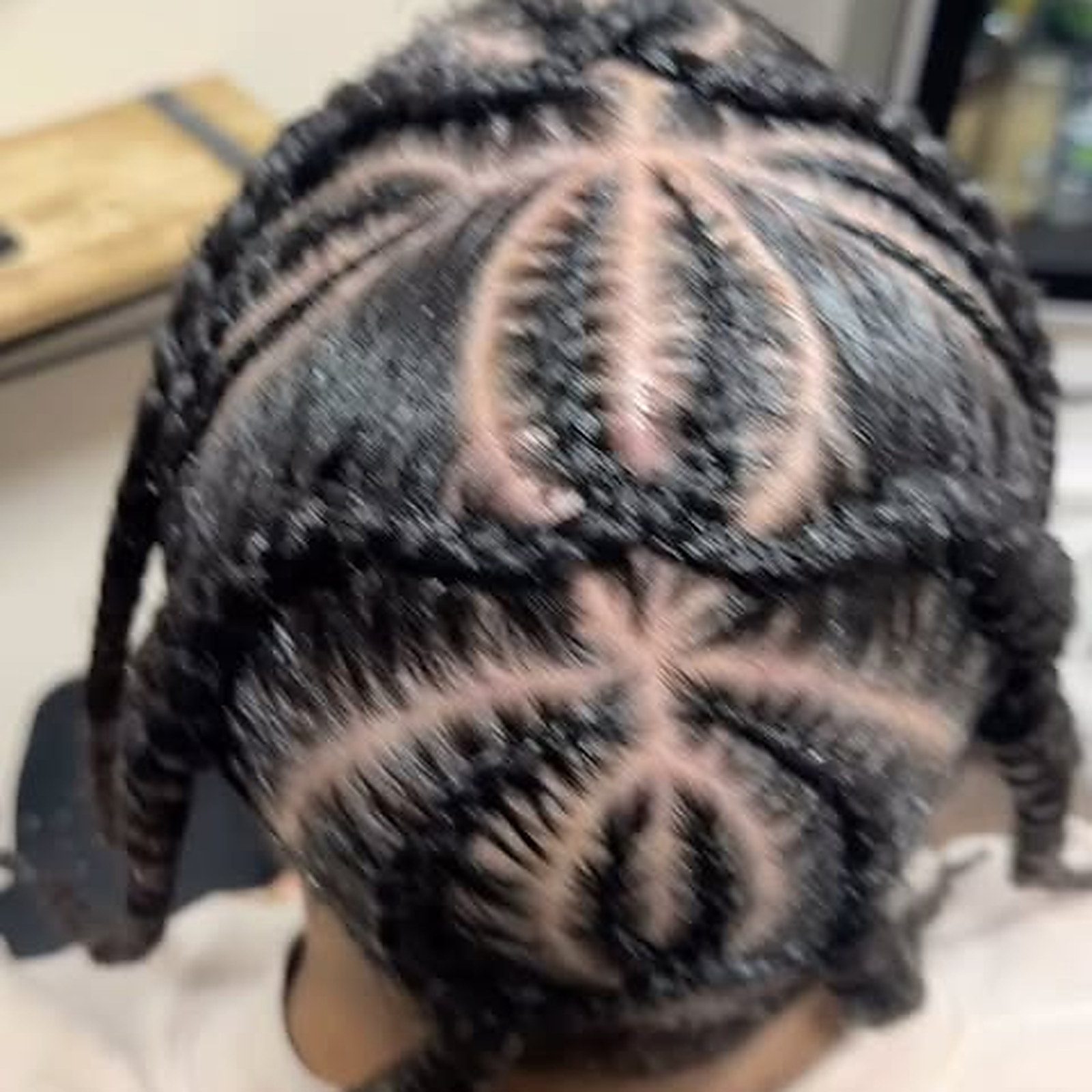 Men’s cornrows from above — Rows braided back from a star-shaped part